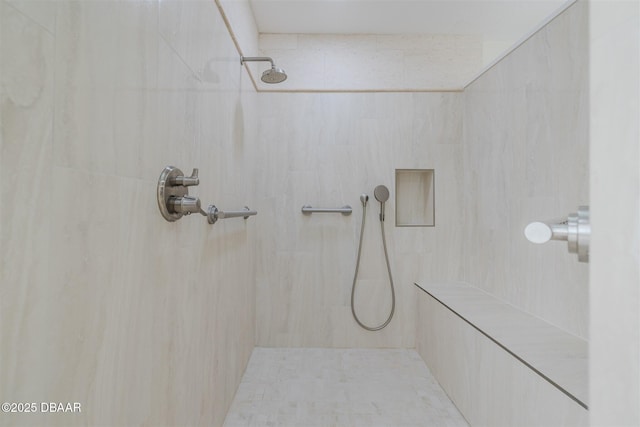 bathroom featuring a tile shower