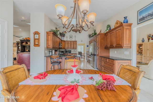 dining space featuring light tile patterned flooring and a chandelier