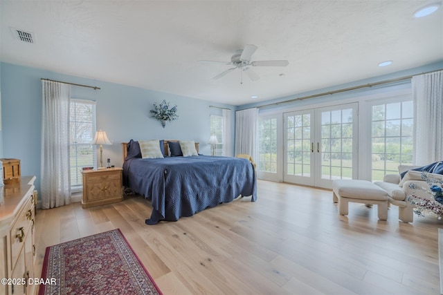 bedroom with french doors, ceiling fan, access to exterior, and light hardwood / wood-style flooring