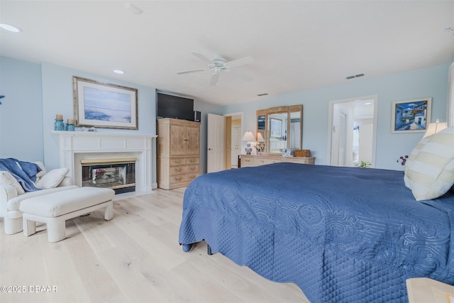 bedroom with ceiling fan and light hardwood / wood-style flooring