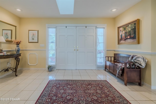 tiled entrance foyer with a skylight