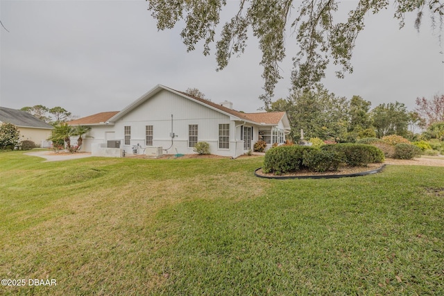 rear view of property with a lawn