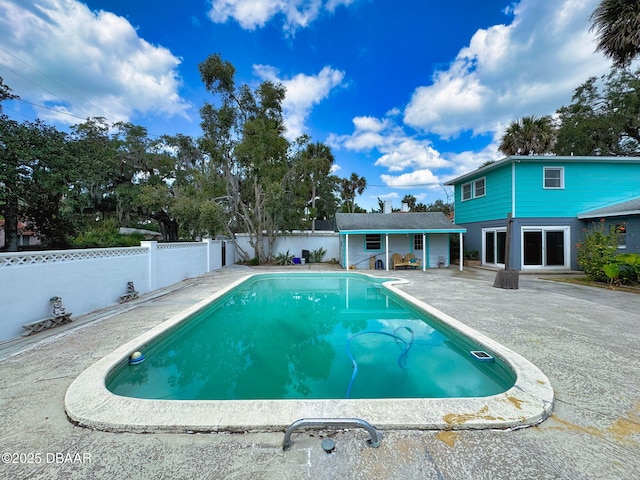 view of pool with an outdoor structure and a patio area