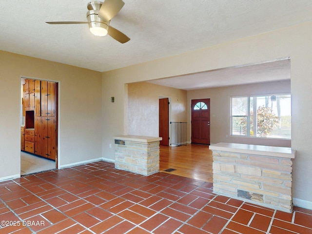 entryway with ceiling fan and a textured ceiling