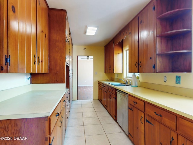 kitchen with dishwasher, sink, and light tile patterned floors