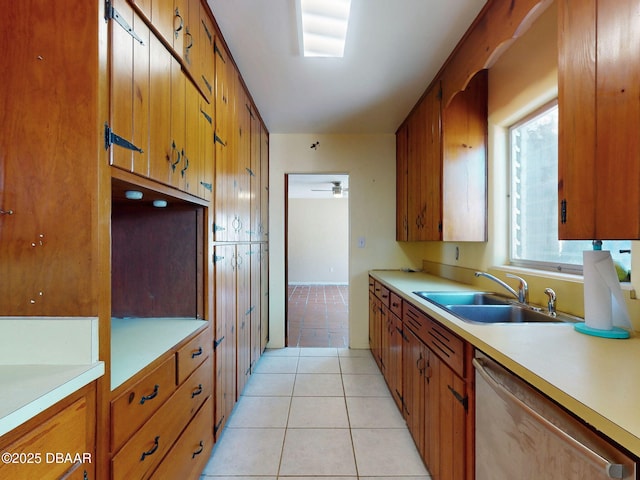 kitchen featuring light tile patterned flooring, stainless steel dishwasher, and sink