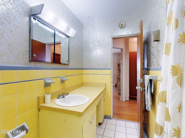 bathroom featuring vanity, tile patterned floors, and tile walls