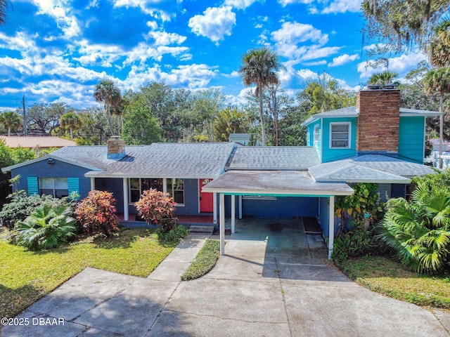 view of front facade with a carport and a front yard