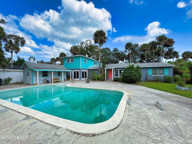 view of swimming pool with an outbuilding and a patio