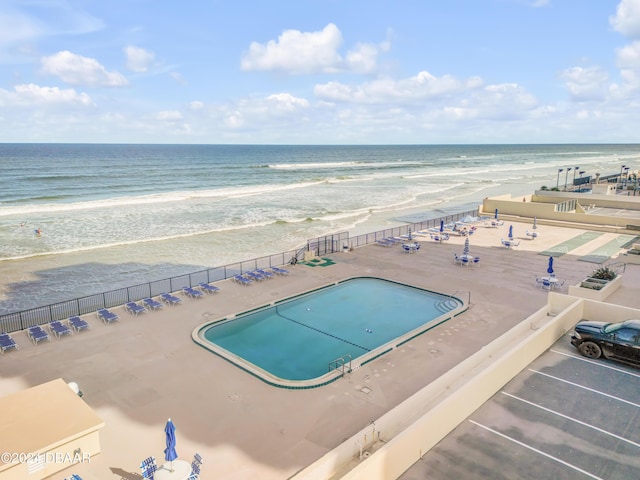 view of pool with a view of the beach and a water view