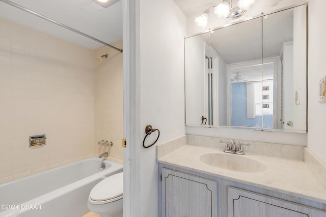 full bathroom with tiled shower / bath combo, toilet, and vanity