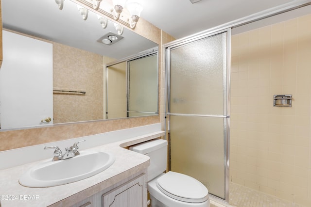 bathroom with an enclosed shower, vanity, and toilet