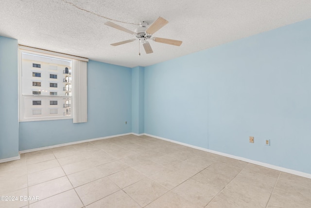 unfurnished room featuring light tile patterned floors, a textured ceiling, and ceiling fan