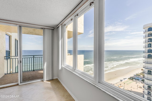 unfurnished sunroom featuring plenty of natural light and a water view