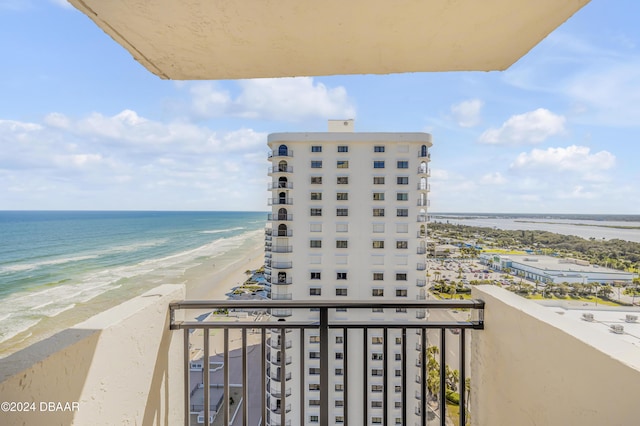 balcony featuring a beach view and a water view