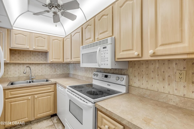 kitchen featuring ceiling fan, sink, white appliances, light brown cabinetry, and light tile patterned flooring