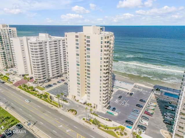 birds eye view of property featuring a water view and a view of the beach