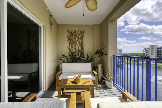 balcony featuring a water view, outdoor lounge area, and ceiling fan