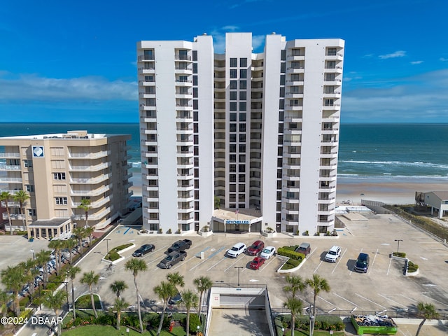 view of property featuring a beach view and a water view