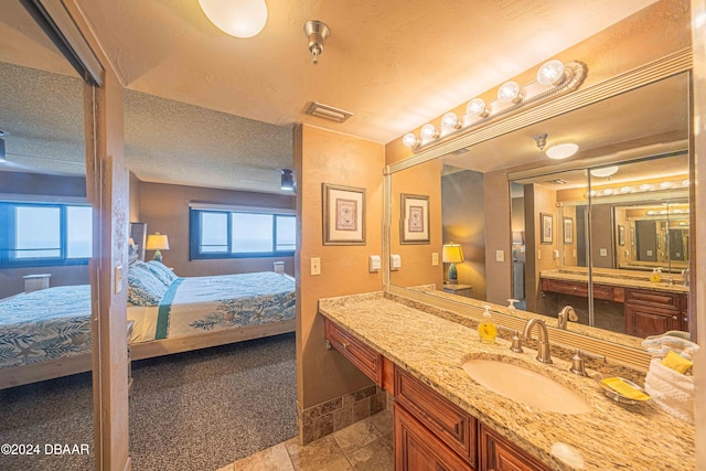 bathroom with vanity and a textured ceiling