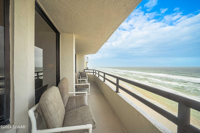 balcony with a beach view and a water view