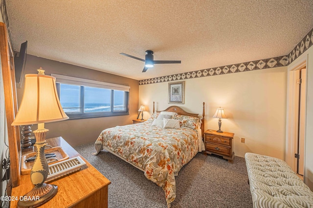 bedroom featuring a textured ceiling, ceiling fan, and dark carpet