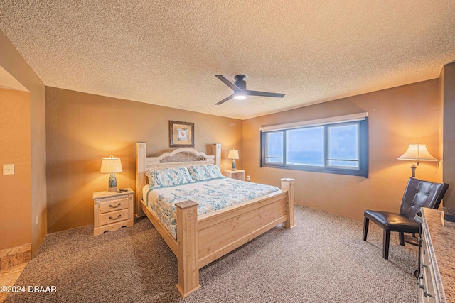 carpeted bedroom with a textured ceiling and ceiling fan