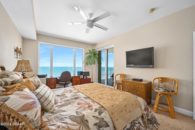 bedroom featuring light colored carpet, ceiling fan, a textured ceiling, and access to outside