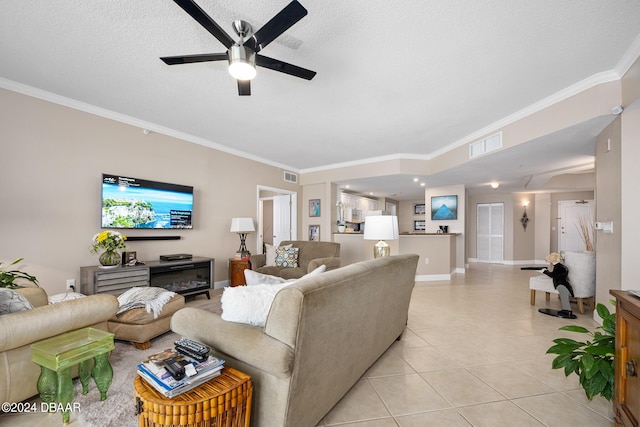 living room with a textured ceiling, light tile patterned floors, and ornamental molding