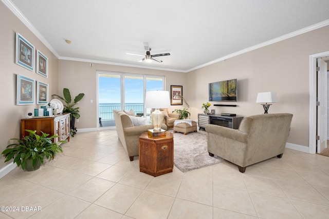 living room with light tile patterned floors, ceiling fan, and crown molding