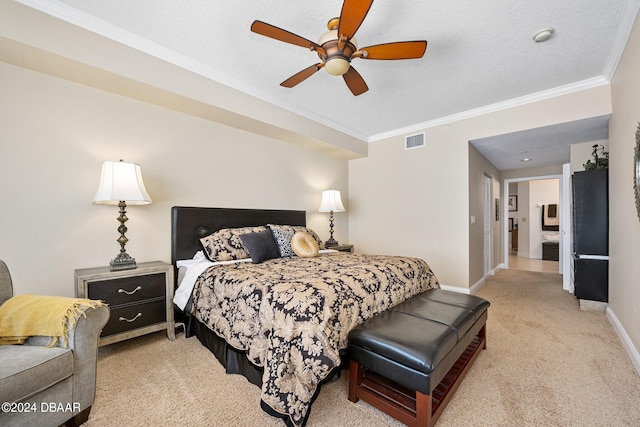 bedroom featuring ceiling fan, a textured ceiling, crown molding, and light colored carpet