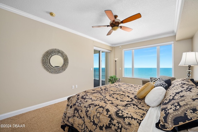 carpeted bedroom featuring a water view, a textured ceiling, ceiling fan, and crown molding