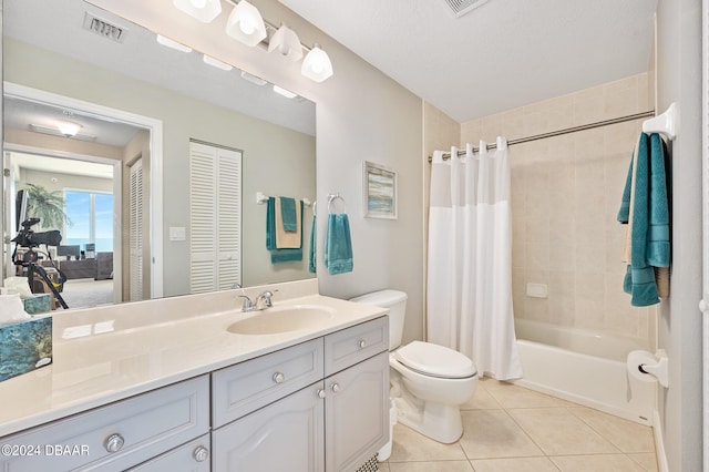 full bathroom featuring toilet, tile patterned floors, a textured ceiling, vanity, and shower / tub combo with curtain