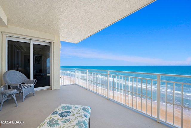 balcony with a view of the beach and a water view