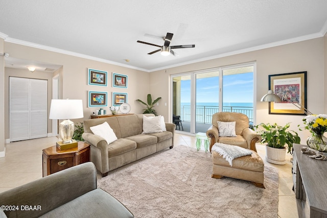 living room featuring ornamental molding, a water view, light tile patterned floors, and ceiling fan