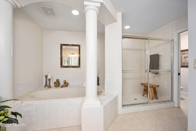 bathroom featuring decorative columns, a textured ceiling, tile patterned floors, and independent shower and bath