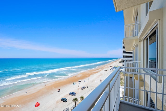 balcony with a view of the beach and a water view