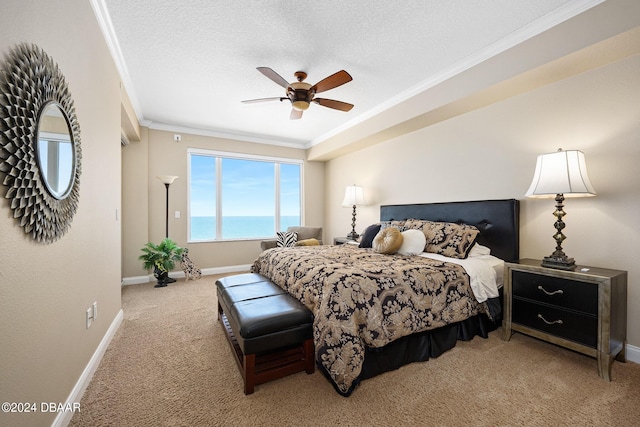 carpeted bedroom with a textured ceiling, a water view, ceiling fan, and crown molding