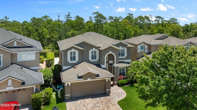 view of property with a garage and a front lawn