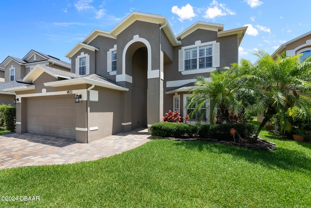 view of front of house with a front lawn and a garage