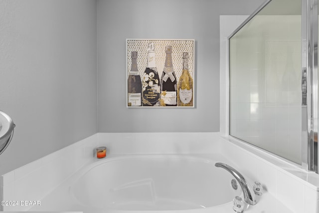 bathroom featuring a relaxing tiled tub