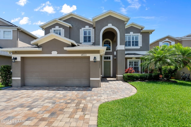 view of front property featuring a front lawn and a garage