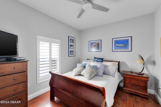 bedroom with dark hardwood / wood-style flooring and ceiling fan