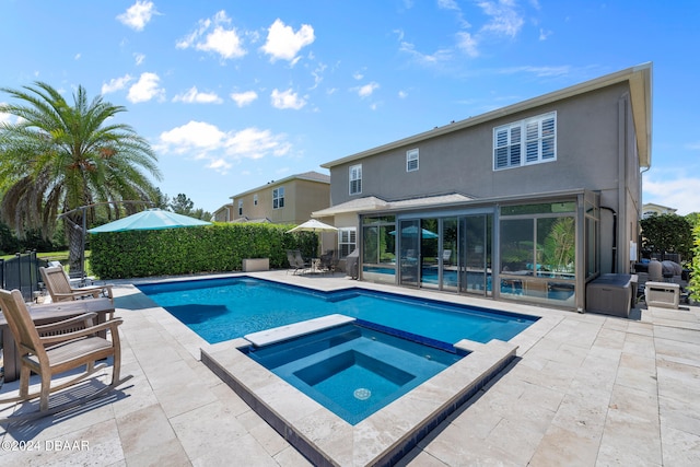 view of swimming pool featuring a patio and an in ground hot tub