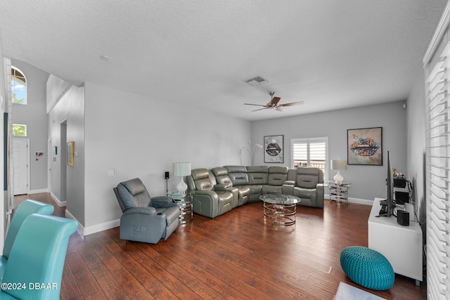 living room with ceiling fan, a textured ceiling, and dark hardwood / wood-style flooring