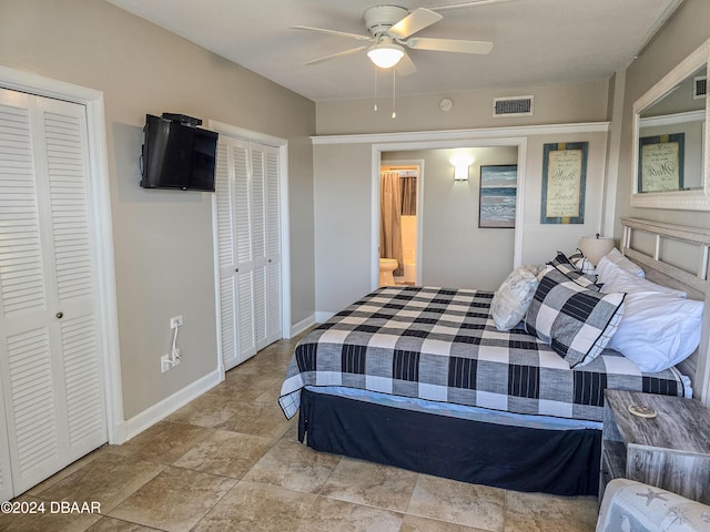 bedroom with ceiling fan and two closets