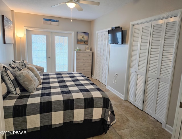 tiled bedroom featuring multiple closets, ceiling fan, and french doors