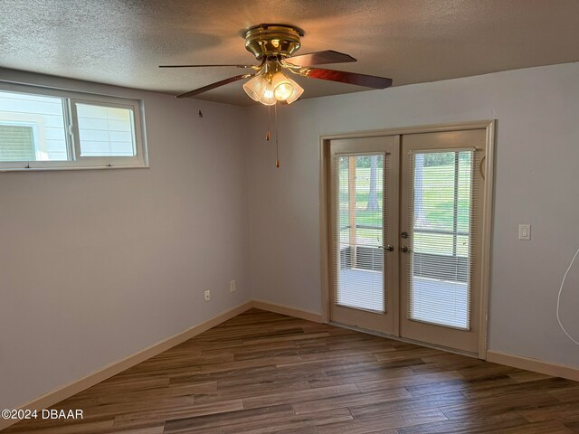 entryway featuring wood-type flooring, a wealth of natural light, and a textured ceiling