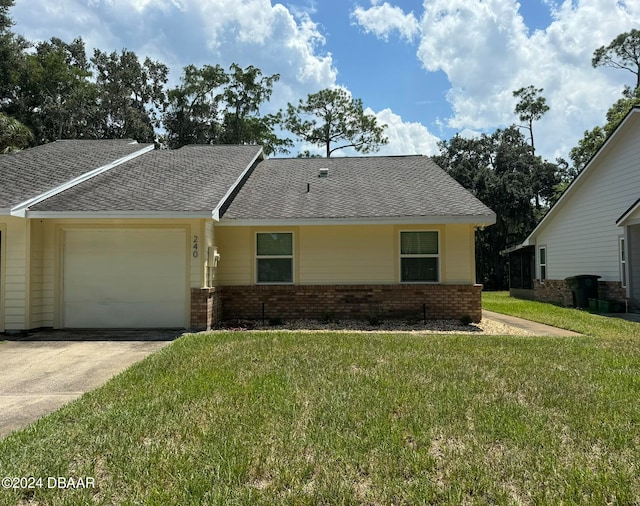 view of front of home featuring a garage and a front lawn