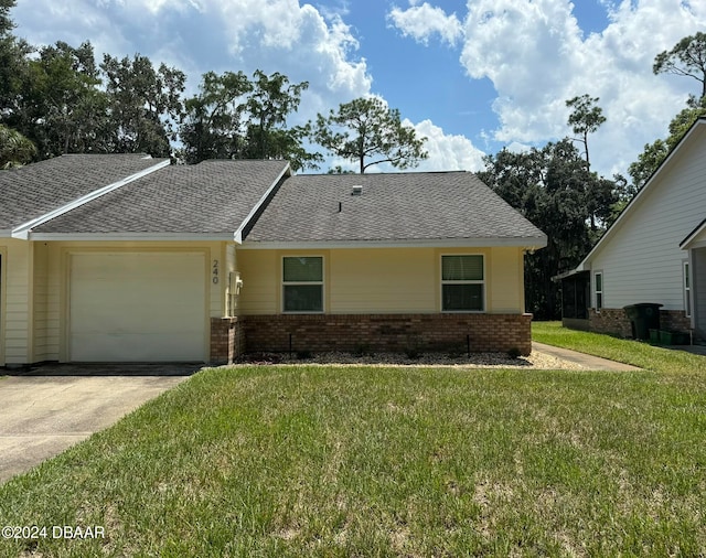 view of front facade featuring a garage and a front lawn